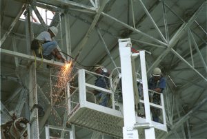 Engineers maintaining the GBT's backup structure