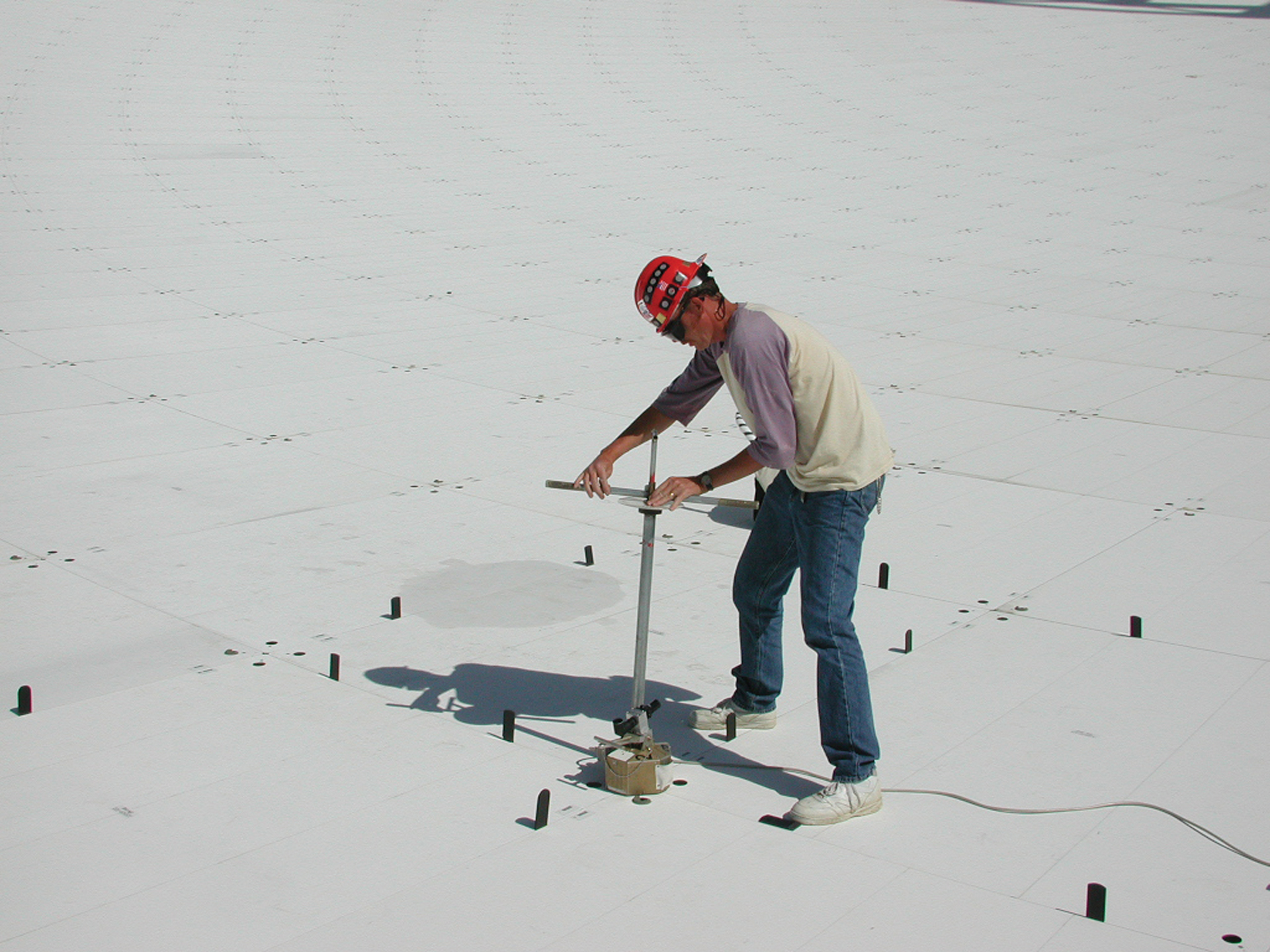 Telescope Technician Nathan Sharp changing a GBT surface panel position