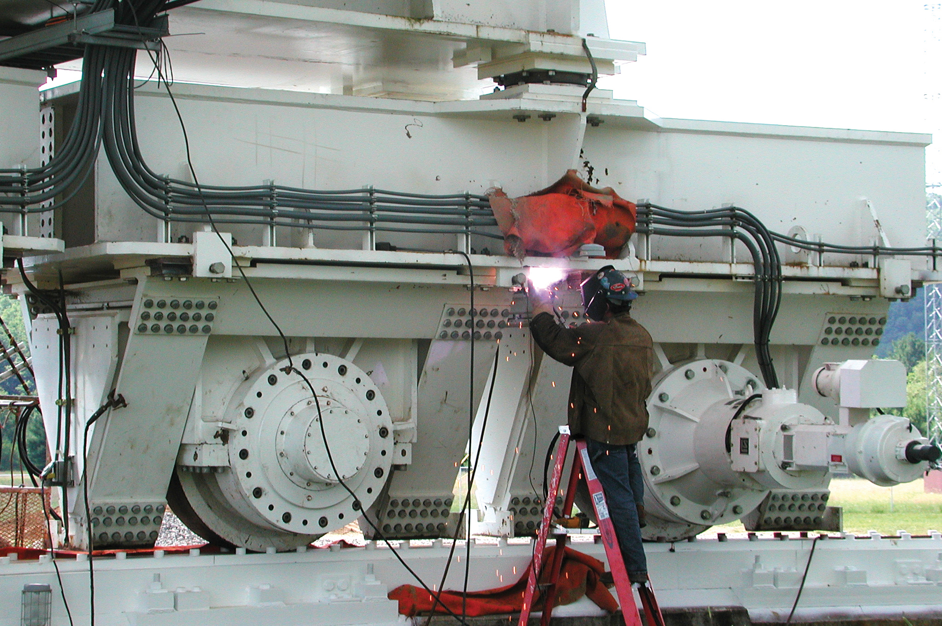 Technician doing welding work on a GBT track truck