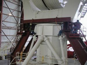 Technicians removing the base of a VLA antenna