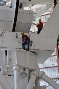 Technicians maintaining a VLA antenna