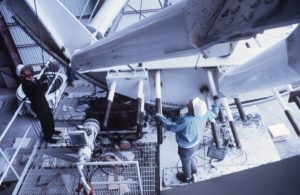 Technicians inspecting a VLA antenna's elevation gear