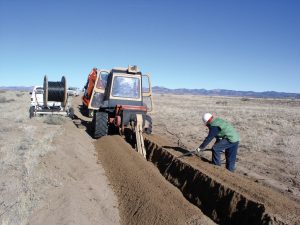 Digging trenches for fiber optic lines at The VLA