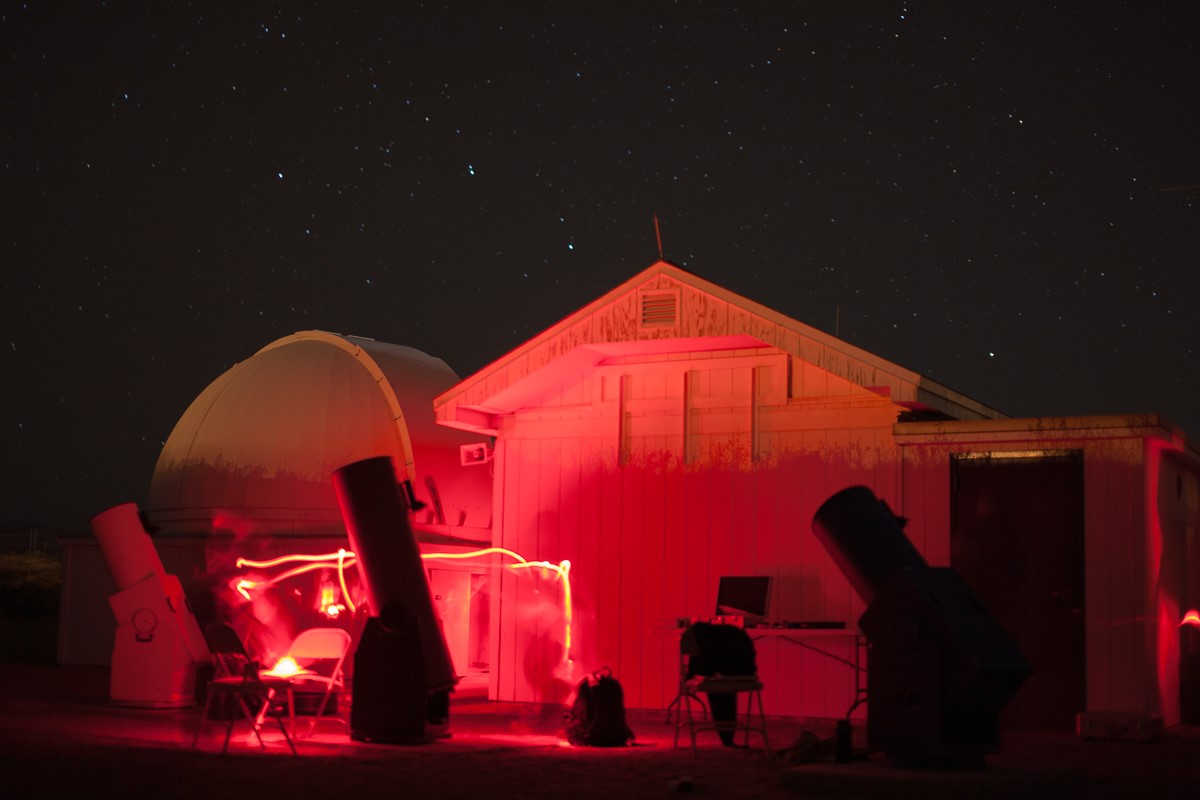 Etscorn Observatory bathed in red light at night time.