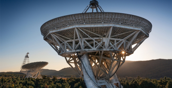 GBO Telescope in the distance with mountain line and sunburst