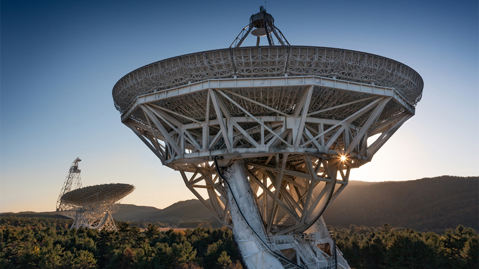 GBO Telescope in the distance with mountain line and sunburst